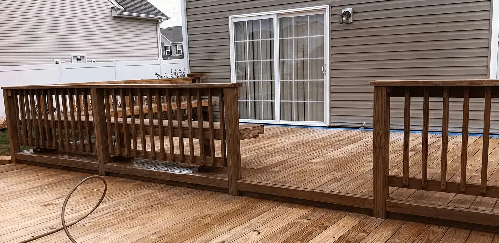 Deck sealing service protecting a backyard wood deck and railings in Bradenton, FL