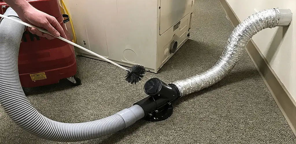 Dryer vent cleaning service removing lint from a dryer duct connection in Bradenton, FL