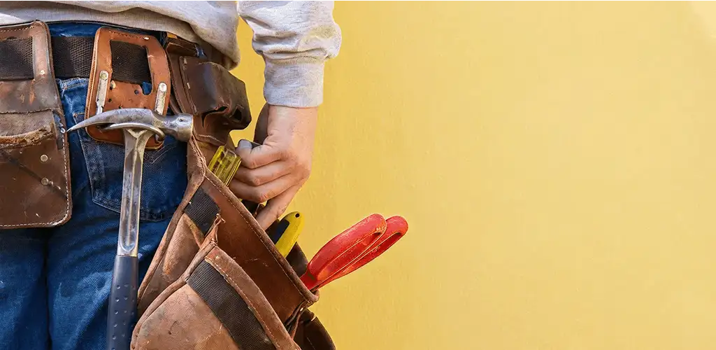 Handyman with tool belt ready for home repairs and maintenance in Bradenton, FL