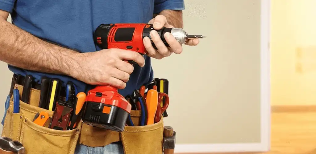 Handyman holding a power drill for home repairs and installations in Bradenton, FL