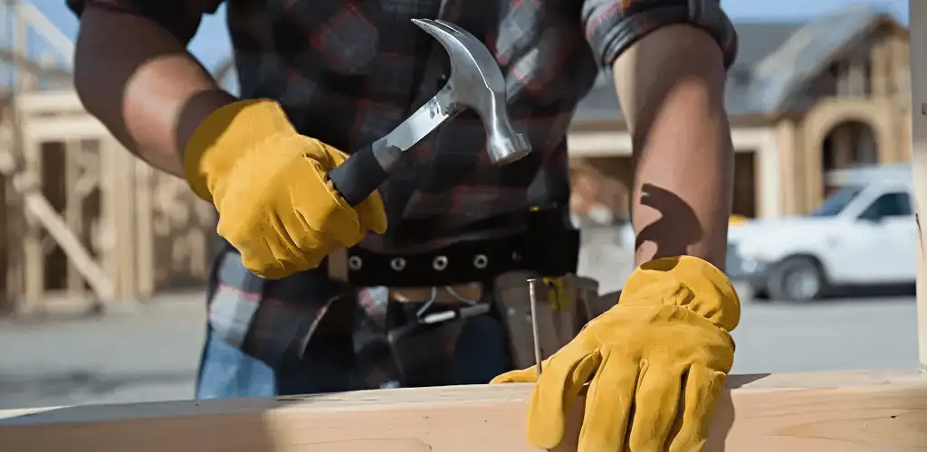 Handyman fixing wood trim with a hammer for home repairs in Bradenton, FL