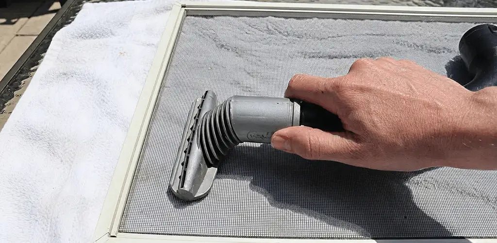 Window screen repair cleaning and fixing a damaged screen mesh in Bradenton, FL