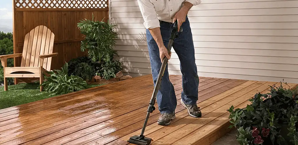 Deck staining service applying stain to a backyard wood deck in Bradenton, FL